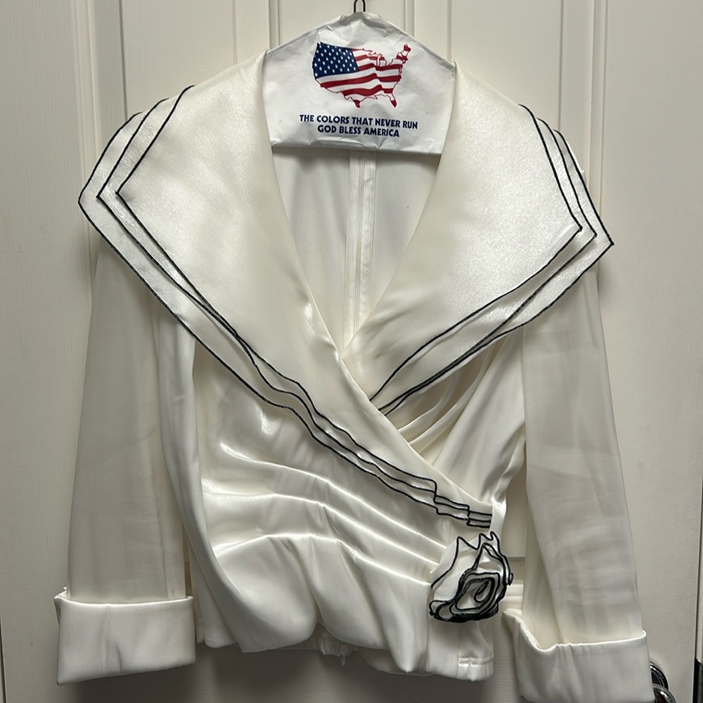 Ivory top with black edging and rose accent at waist.
